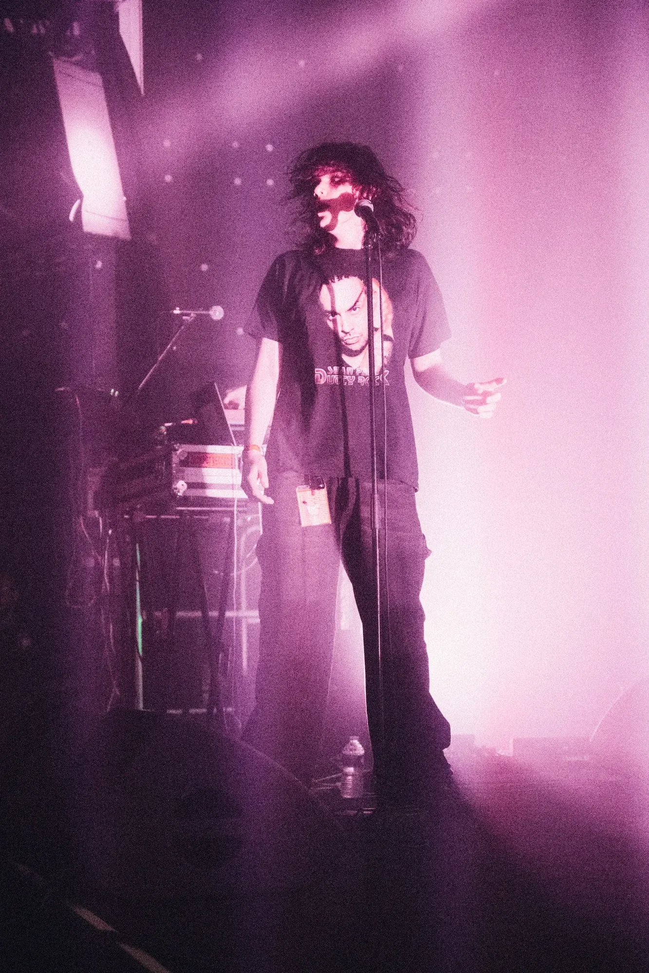 Singer performing under pink stage light, photographed by Helen Milova