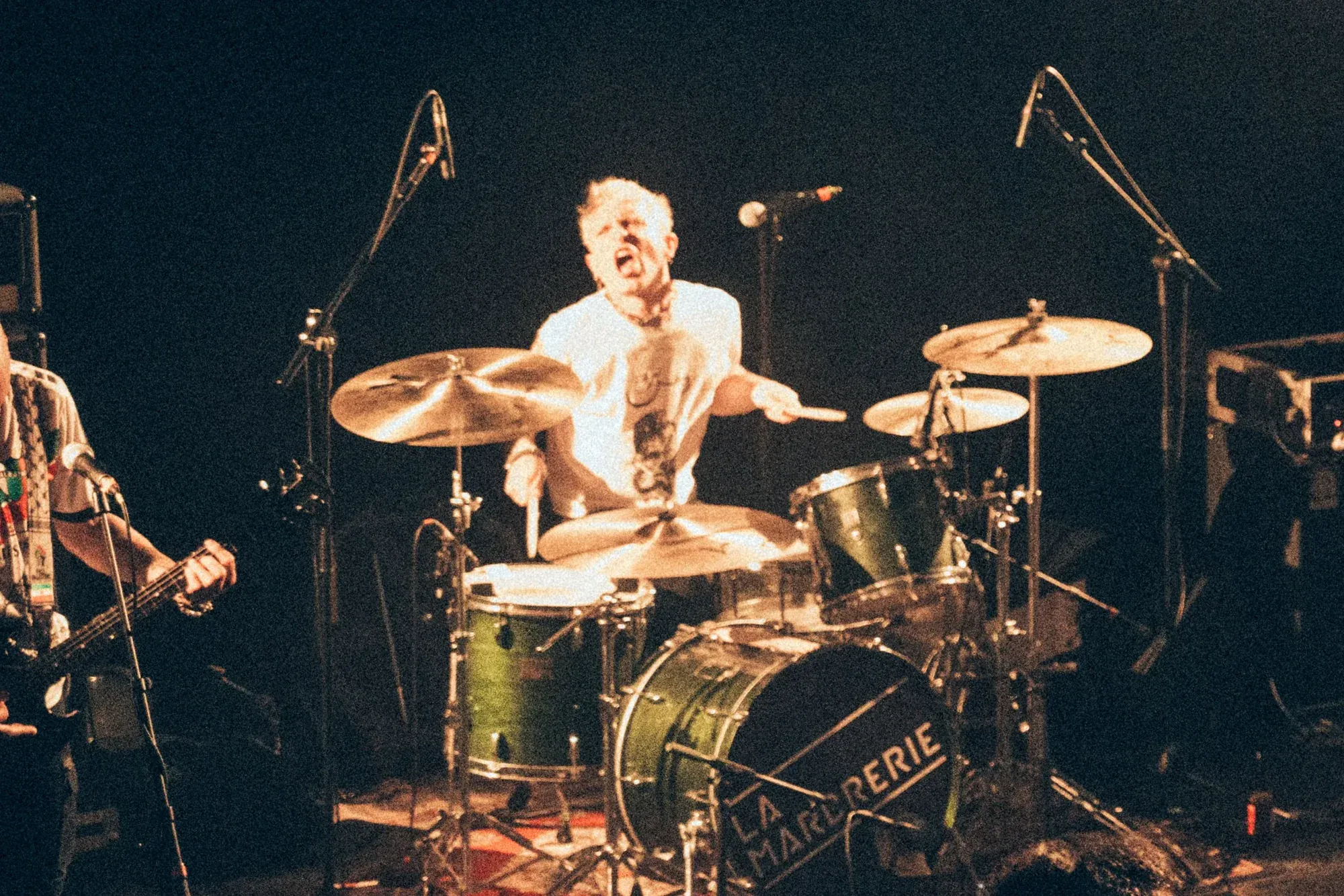 Drummer performing live, photographed by Helen Milova