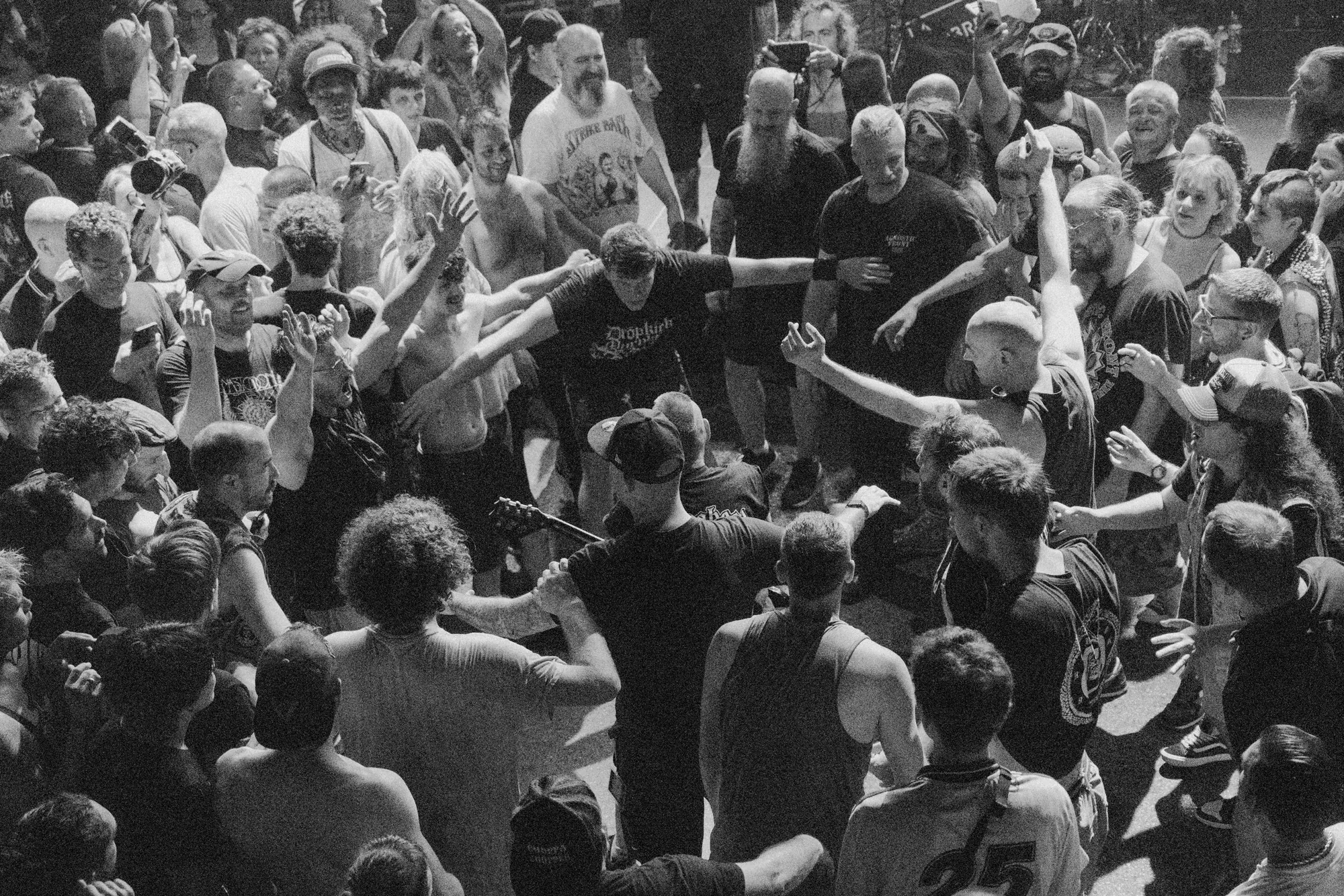 Black-and-white crowd scene at a live show, photographed by Helen Milova